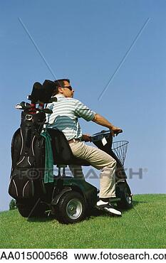 Stock Photo - golfer driving 
electric golf 
caddy. fotosearch 
- search stock 
photos, pictures, 
images, and photo 
clipart
