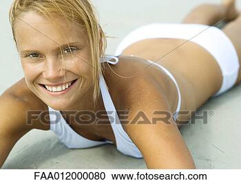 Stock Photography - woman lying on 
beach, smiling, 
close-up. fotosearch 
- search stock 
photos, pictures, 
images, and photo 
clipart