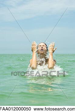 Stock Photography - woman in sea splashing 
face. fotosearch 
- search stock 
photos, pictures, 
images, and photo 
clipart