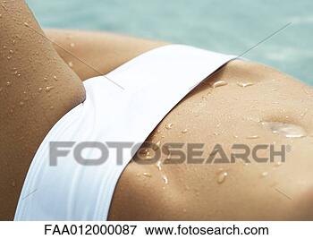 Picture - woman wearing 
bikini, extreme 
close-up of abdomen. 
fotosearch - search 
stock photos, 
pictures, images, 
and photo clipart
