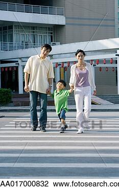 Stock Photo - boy crossing crosswalk, 
hand in hand with 
parents, full 
length. fotosearch 
- search stock 
photos, pictures, 
images, and photo 
clipart