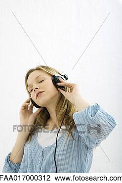 Stock Photo - teenage girl listening 
to headphones, 
portrait. fotosearch 
- search stock 
photos, pictures, 
images, and photo 
clipart