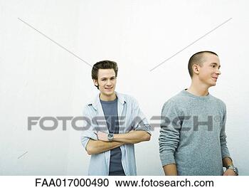 Stock Photography - two young adult 
men, one looking 
at camera, the 
other looking 
away. fotosearch 
- search stock 
photos, pictures, 
images, and photo 
clipart