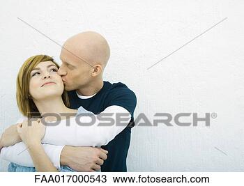 Stock Photo - young couple, 
man kissing woman's 
cheek woman from 
behind. fotosearch 
- search stock 
photos, pictures, 
images, and photo 
clipart