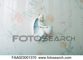 Stock Photography - angel knickknack 
hanging on wall. 
fotosearch - search 
stock photos, 
pictures, images, 
and photo clipart