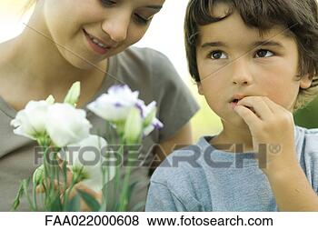 Stock Photo - boy and young 
woman with flowers, 
boy looking up. 
fotosearch - search 
stock photos, 
pictures, images, 
and photo clipart