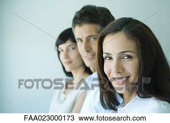 Stock Photo - business team 
in a row smiling 
at camera,  head 
and shoulders, 
 focus. fotosearch 
- search stock 
photos, pictures, 
images, and photo 
clipart