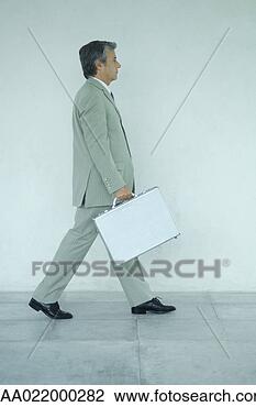 Stock Photo - businessman carrying 
briefcase, side 
view, full length 
portrait. fotosearch 
- search stock 
photos, pictures, 
images, and photo 
clipart