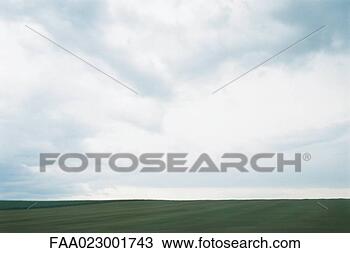 Stock Photo - green field and 
cloudy sky. fotosearch 
- search stock 
photos, pictures, 
images, and photo 
clipart