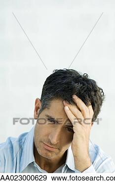 Stock Photograph - mature man holding 
head, looking 
at camera, portrait. 
fotosearch - search 
stock photos, 
pictures, images, 
and photo clipart