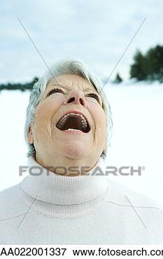 Picture - senior woman laughing 
in snowy landscape, 
portrait. fotosearch 
- search stock 
photos, pictures, 
images, and photo 
clipart