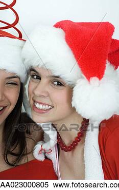 Stock Image - two young female 
friends dressed 
in christmas costumes, 
 smiling at. fotosearch 
- search stock 
photos, pictures, 
images, and photo 
clipart