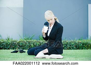 Stock Photo - young businesswoman 
sitting on the 
ground outdoors, 
 reading book. 
fotosearch - search 
stock photos, 
pictures, images, 
and photo clipart