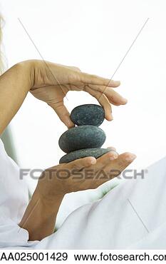 Stock Photograph - person stacking 
pebbles in hand, 
cropped view. 
fotosearch - search 
stock photos, 
pictures, images, 
and photo clipart