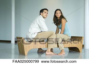 Stock Photograph - young couple sitting 
face to face on 
bench, both looking 
away. fotosearch 
- search stock 
photos, pictures, 
images, and photo 
clipart