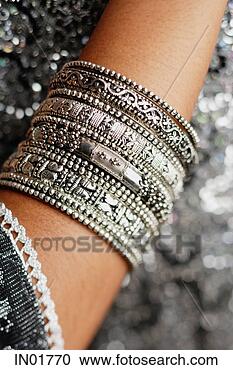 Stock Photography - close-up of woman's 
arm with silver 
bangles. fotosearch 
- search stock 
photos, pictures, 
images, and photo 
clipart