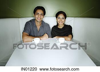 Stock Photography - couple sitting 
side by side looking 
at camera. fotosearch 
- search stock 
photos, pictures, 
images, and photo 
clipart