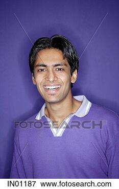 Picture - young man wearing 
purple shirt smiling 
at camera. fotosearch 
- search stock 
photos, pictures, 
images, and photo 
clipart