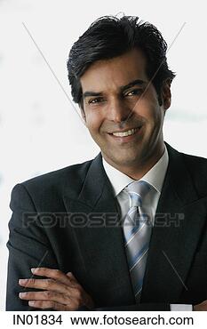 Stock Photo - businessman smiling 
at camera, arms 
crossed. fotosearch 
- search stock 
photos, pictures, 
images, and photo 
clipart
