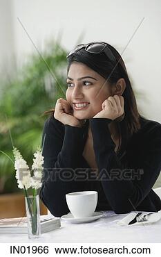 Stock Photo - woman in cafe, 
hands on chin, 
looking away. 
fotosearch - search 
stock photos, 
pictures, images, 
and photo clipart