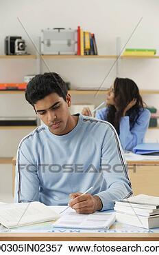 Picture - young couple studying 
at desks. fotosearch 
- search stock 
photos, pictures, 
images, and photo 
clipart