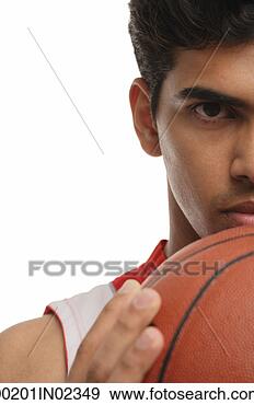 Stock Photograph - young man with 
basketball looking 
at camera. fotosearch 
- search stock 
photos, pictures, 
images, and photo 
clipart