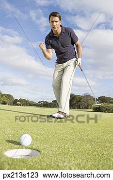 Stock Photo - golfer and golf 
ball next to hole. 
fotosearch - search 
stock photos, 
pictures, images, 
and photo clipart