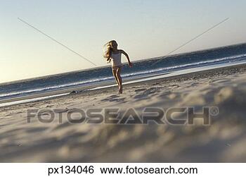 Stock Photo - girl running toward 
the ocean. fotosearch 
- search stock 
photos, pictures, 
images, and photo 
clipart
