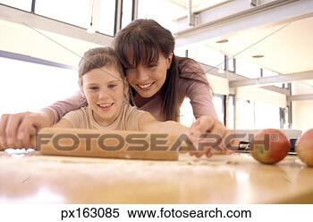 Stock Image - view of a young 
girl and her mother 
making pie crust. 
fotosearch - search 
stock photos, 
pictures, images, 
and photo clipart