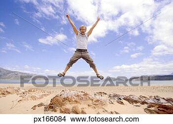 Stock Photo - view of a young 
man jumping for 
joy at the beach. 
fotosearch - search 
stock photos, 
pictures, images, 
and photo clipart