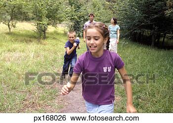 Stock Photo - view of a brother 
and sister chasing 
each other through 
rural setting. 
fotosearch - search 
stock photos, 
pictures, images, 
and photo clipart