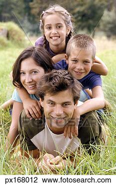 Stock Photo - view of a family 
posing for the 
camera in tall 
grass. fotosearch 
- search stock 
photos, pictures, 
images, and photo 
clipart