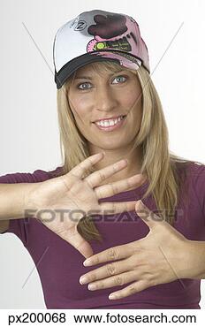 Stock Photo - woman in cap making 
a square with 
her hands. fotosearch 
- search stock 
photos, pictures, 
images, and photo 
clipart