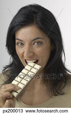 Stock Photo - woman taking a 
tiny bite of white 
chocolate. fotosearch 
- search stock 
photos, pictures, 
images, and photo 
clipart