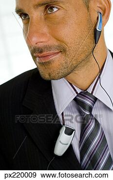 Stock Photograph - business man with 
ear piece. fotosearch 
- search stock 
photos, pictures, 
images, and photo 
clipart