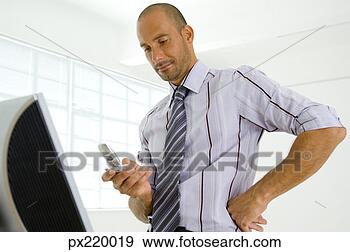 Stock Photograph - businessman with 
cell phone. fotosearch 
- search stock 
photos, pictures, 
images, and photo 
clipart