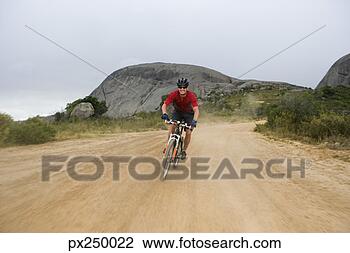 Stock Photo - man mountain biking. 
fotosearch - search 
stock photos, 
pictures, images, 
and photo clipart