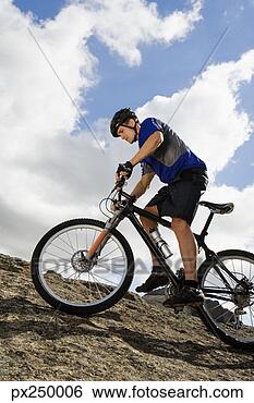 Stock Photo - man riding mountain 
bike. fotosearch 
- search stock 
photos, pictures, 
images, and photo 
clipart