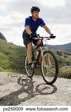 Stock Photograph - man riding mountain 
bike. fotosearch 
- search stock 
photos, pictures, 
images, and photo 
clipart