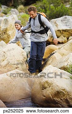 Stock Image - couple hiking 
outdoors. fotosearch 
- search stock 
photos, pictures, 
images, and photo 
clipart