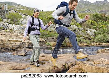 Stock Photo - couple walking 
across stream. 
fotosearch - search 
stock photos, 
pictures, images, 
and photo clipart