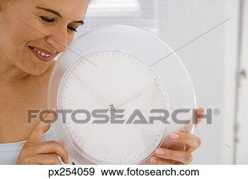 Stock Photograph - woman with clock. 
fotosearch - search 
stock photos, 
pictures, images, 
and photo clipart