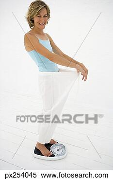 Stock Image - woman on scale. 
fotosearch - search 
stock photos, 
pictures, images, 
and photo clipart