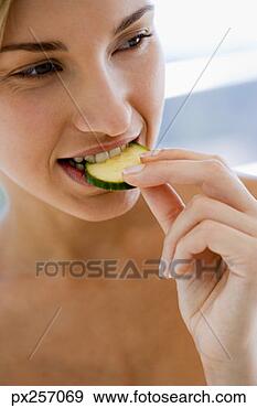 Stock Photograph - woman eating cucumber. 
fotosearch - search 
stock photos, 
pictures, images, 
and photo clipart