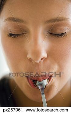 Stock Photography - woman with spoon 
in mouth. fotosearch 
- search stock 
photos, pictures, 
images, and photo 
clipart