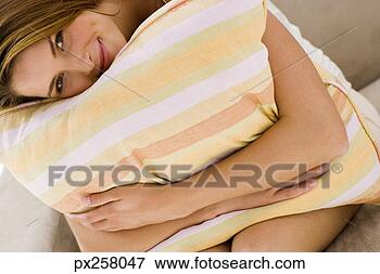 Picture - woman holding 
pillow and resting 
face against it. 
fotosearch - search 
stock photos, 
pictures, images, 
and photo clipart