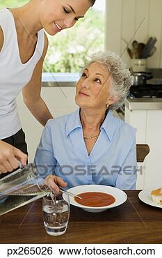 Stock Photo - woman refilling 
glass of water. 
fotosearch - search 
stock photos, 
pictures, images, 
and photo clipart