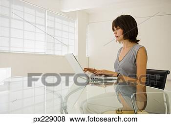 Stock Photo - woman with a laptop 
computer. fotosearch 
- search stock 
photos, pictures, 
images, and photo 
clipart
