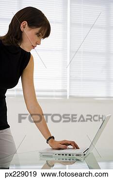 Stock Photograph - woman with a laptop 
computer. fotosearch 
- search stock 
photos, pictures, 
images, and photo 
clipart