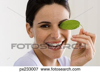 Picture - woman with leaf. 
fotosearch - search 
stock photos, 
pictures, images, 
and photo clipart
